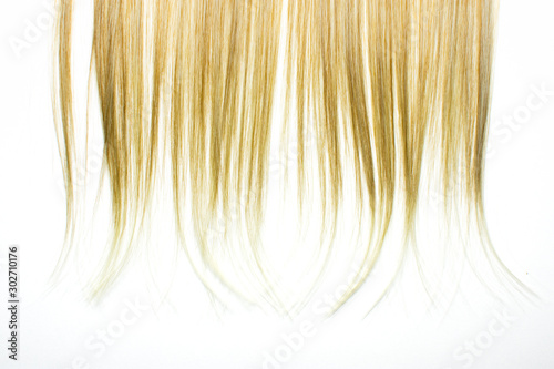 Piece of blonde brown hair on white isolated background