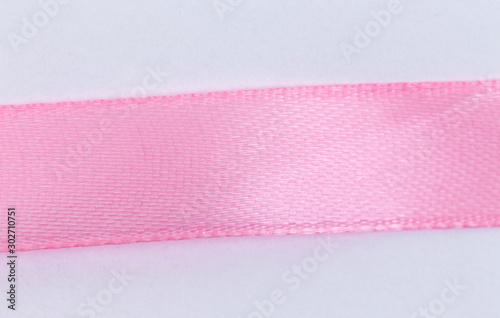 Closeup Pink ribbon on white background with copy space for text