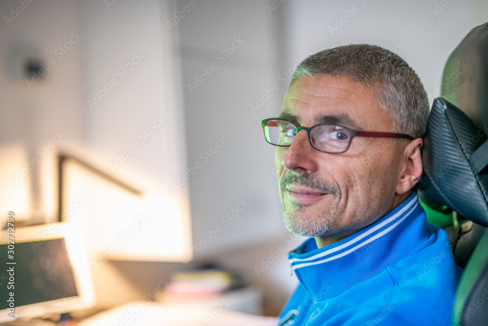 Young man with eyeglasses working at his home desk