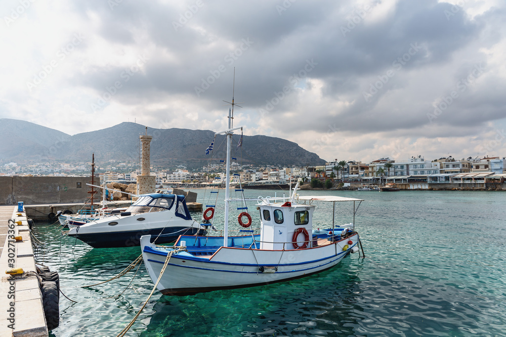 view of small boats in the harbor in the Greek resort town of Hersonissos