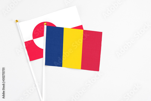 Chad and Greenland stick flags on white background. High quality fabric, miniature national flag. Peaceful global concept.White floor for copy space. photo