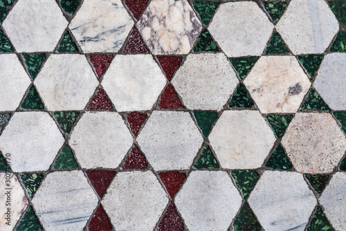 Fragment of a marble tile floor of various colors and sizes in the Roman Church of the Holy Cross Jerusalem