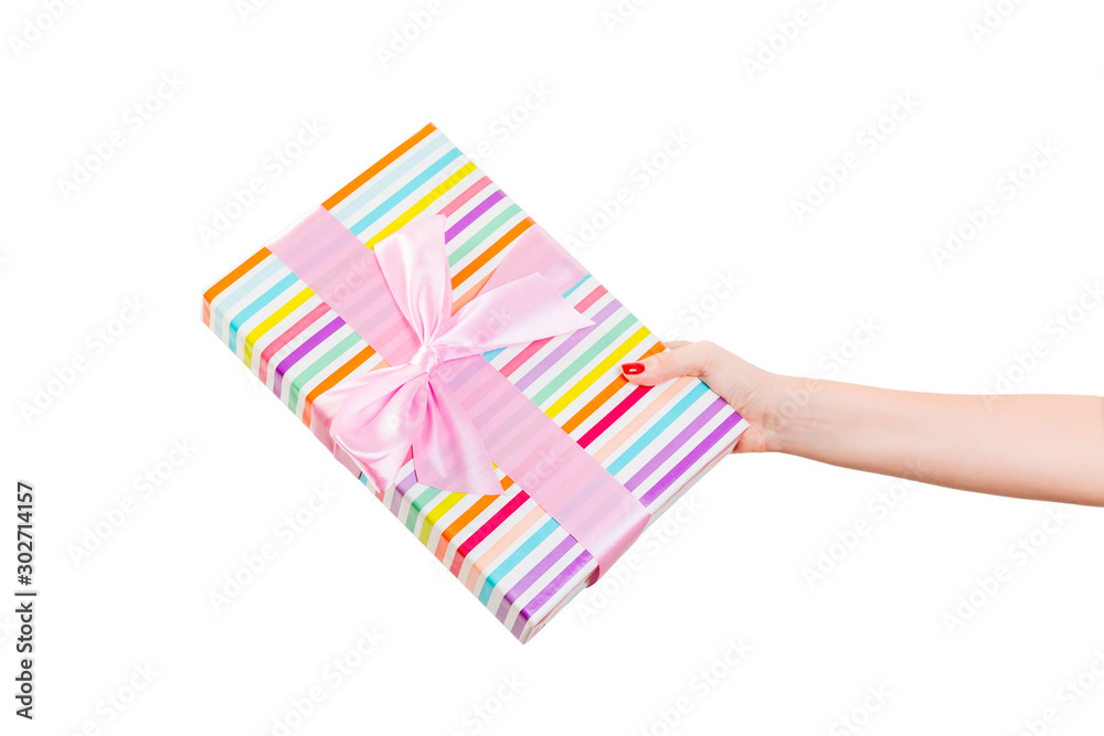 Woman hands give wrapped Christmas or other holiday handmade present in colored paper with pink ribbon. Isolated on white background, top view. thanksgiving Gift box concept Woman hands give wrapped Christmas or other holiday handmade present in colored paper with pink ribbon. Isolated on white background, top view. thanksgiving Gift box concept