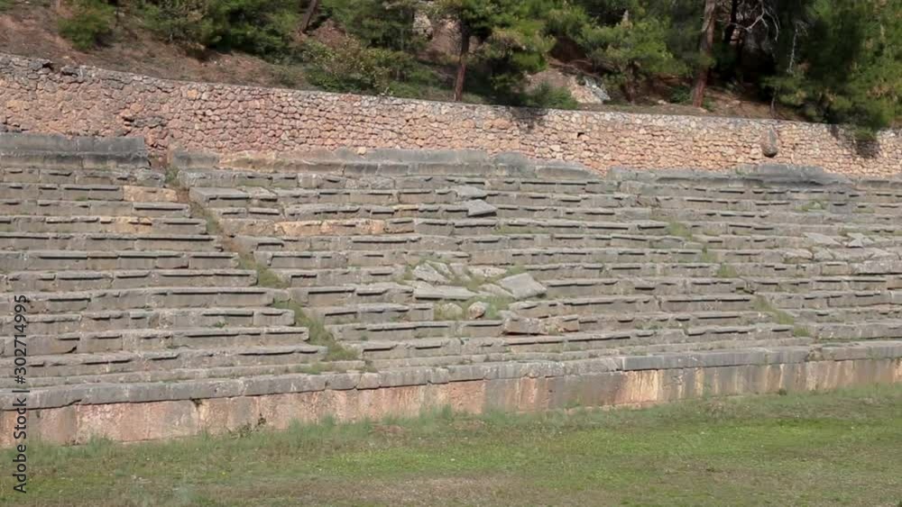 Close-up, panoramic view of the stonewall benches and seats of the Stadium ruins of Delphi sanctuary in Phocis, Greece. Close-up, panoramic view of the stonewall benches and seats of the Stadium ruins of Delphi sanctuary in Phocis, Greece.