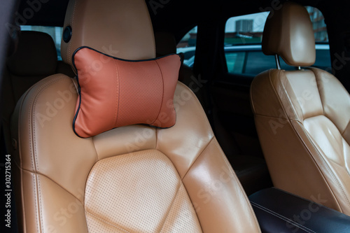 The seats in the car are made of brown leather with pillows for the neck and rest during long trips and travels. © Aleksandr Kondratov