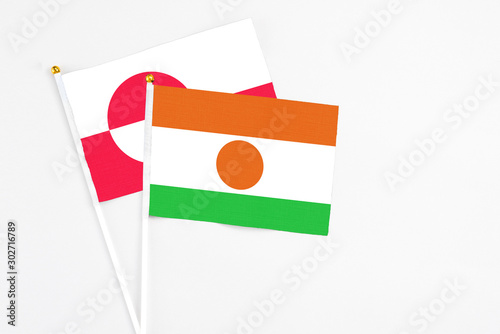 Niger and Greenland stick flags on white background. High quality fabric, miniature national flag. Peaceful global concept.White floor for copy space. Free Download Niger and Greenland stick flags on white background. High quality fabric, miniature national flag. Peaceful global concept.White floor for copy space. - GFXLoad