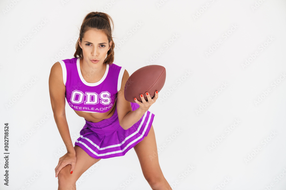Cheerleader woman holding handball for american football. Cheerleader woman holding handball for american football.