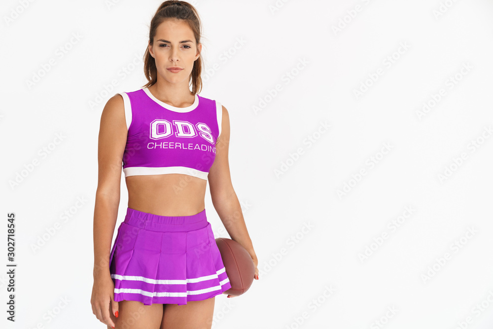 Cheerleader woman holding handball for american football. Cheerleader woman holding handball for american football.