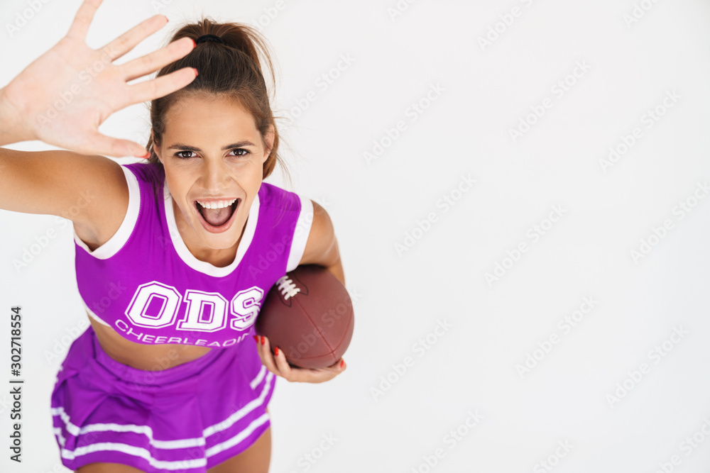 Cheerleader woman holding handball for american football. Cheerleader woman holding handball for american football.