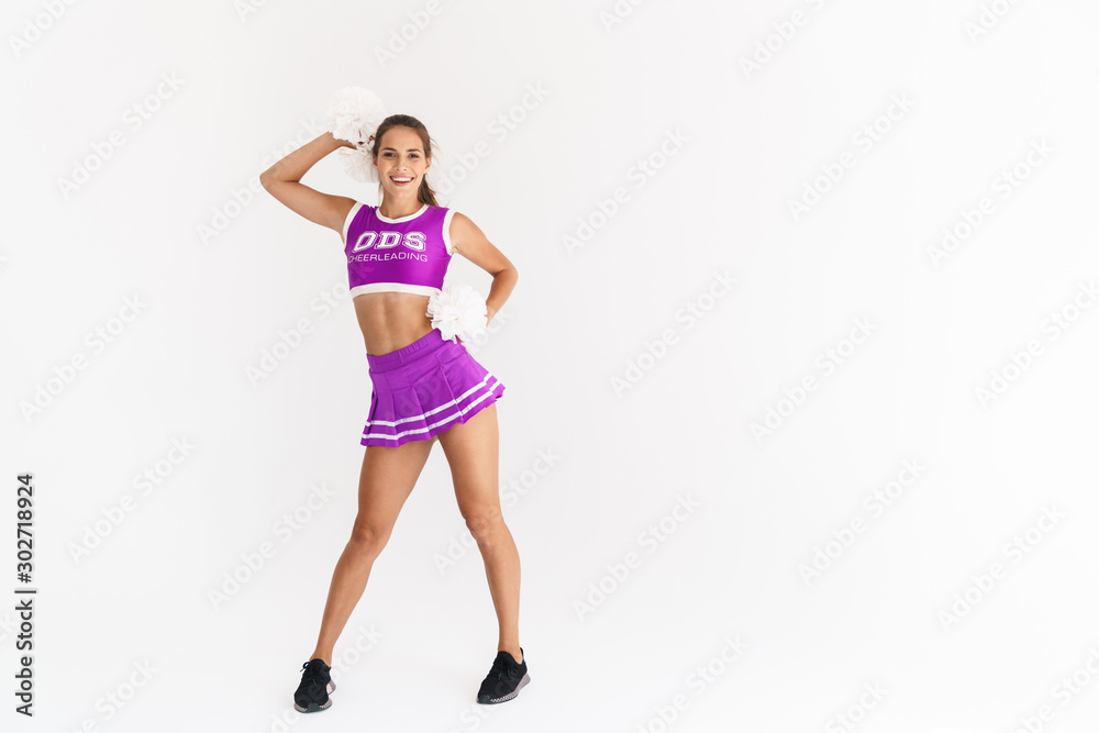 Portrait of smiling cheerleader woman dancing with pom-poms Portrait of smiling cheerleader woman dancing with pom-poms