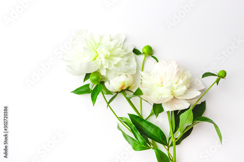 Bouquet of white puffy peonies, light background