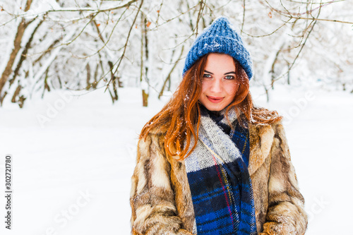 cheerful young woman in the forest. portrait of an attractive girl in winter.