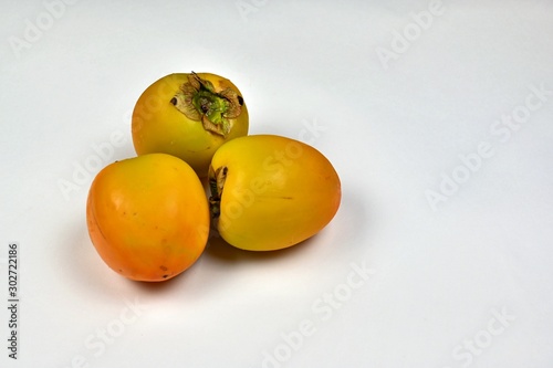 Fresh Persimmon Fruit on White Background