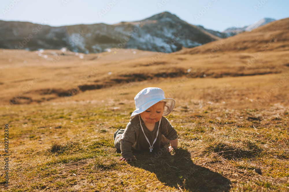 Baby traveler crawling in mountains family lifestyle cute girl child vacations activity outdoor Baby traveler crawling in mountains family lifestyle cute girl child vacations activity outdoor