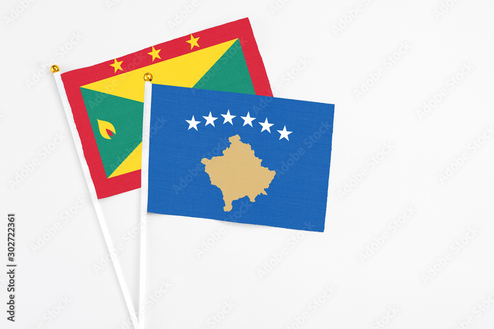 Kosovo and Grenada stick flags on white background. High quality fabric, miniature national flag. Peaceful global concept.White floor for copy space. Kosovo and Grenada stick flags on white background. High quality fabric, miniature national flag. Peaceful global concept.White floor for copy space.
