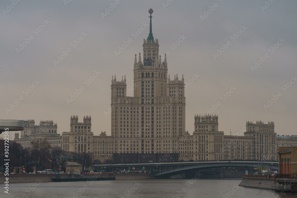 Obraz premium Photography of Stalinist skyscraper on Kotelnicheskaya embankment and Observation Deck Zaryadye Park at autumn day. International touristic concepts.
