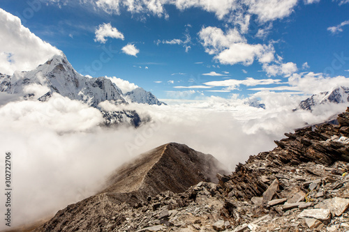 mountains peak including Ama Dablam over the clouds, view from Chukhung Ri on the 3 passes trek in the everest region, Nepal photo