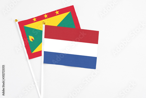 Netherlands and Grenada stick flags on white background. High quality fabric, miniature national flag. Peaceful global concept.White floor for copy space. Free Download Netherlands and Grenada stick flags on white background. High quality fabric, miniature national flag. Peaceful global concept.White floor for copy space. - GFXLoad