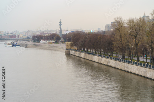 Moscow city embankment, Moskva River and Peter the Great Statue made of Zurab Tsereteli in autumn rainy day. Famous historical monument in natural light. 