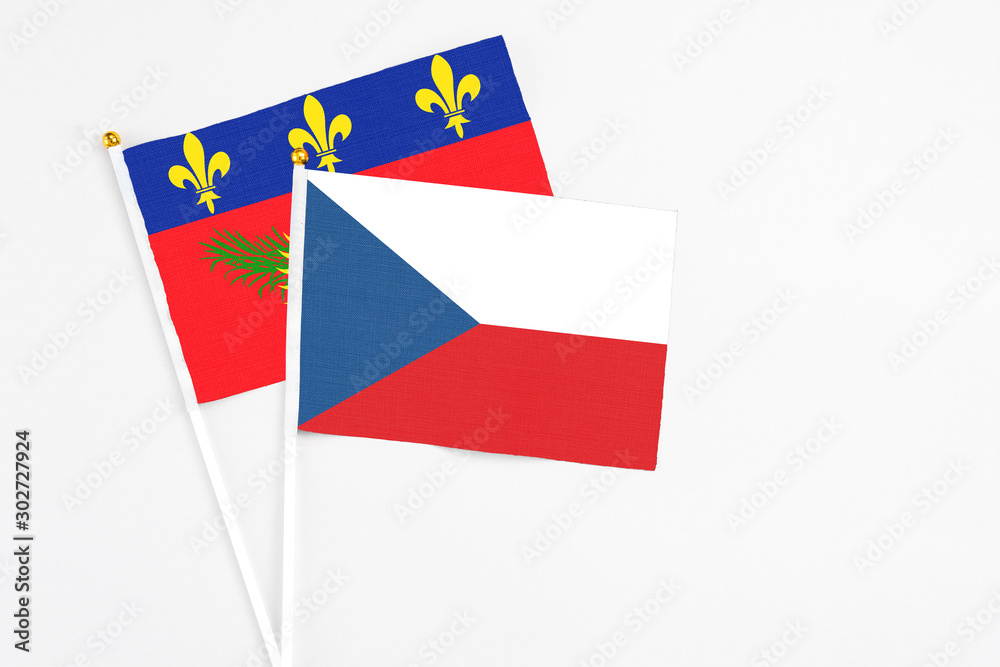 Czech Republic and Guadeloupe stick flags on white background. High quality fabric, miniature national flag. Peaceful global concept.White floor for copy space. Czech Republic and Guadeloupe stick flags on white background. High quality fabric, miniature national flag. Peaceful global concept.White floor for copy space.