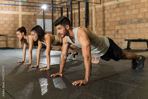 Athletic Friends Working Out At Health Club