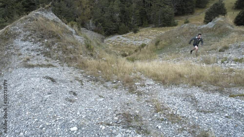 Man trail runner running The Remarkables New Zealand