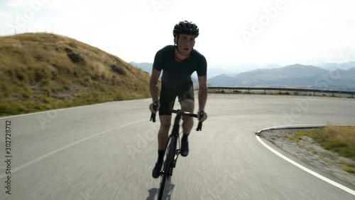 Male cyclist riding bike Lake Wakatipu New Zealand