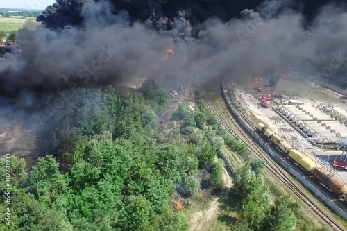 Oil storage fire. The tank farm is burning, black smoke is combu