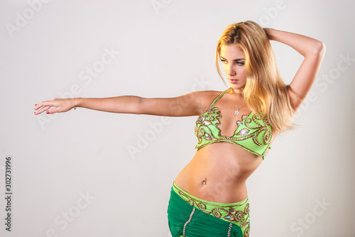 Fotografie Young blonde belly dancer stretching her arm
