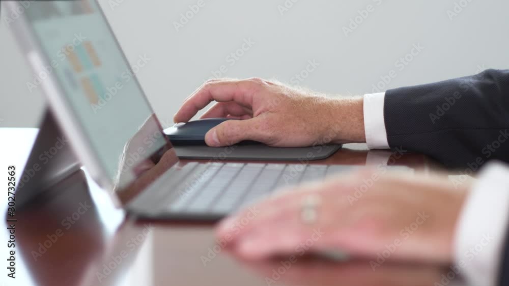 324. Business man scrolling on a mouse on a computer close up of hands 324. Business man scrolling on a mouse on a computer close up of hands
