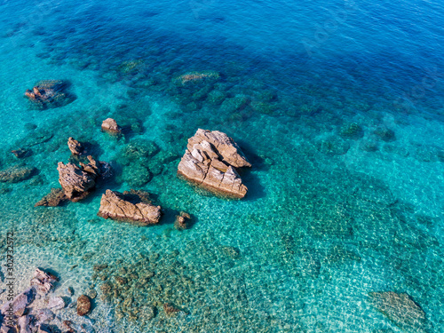 Aerial view of Tropea beach  crystal clear water and rocks that appear on the beach. Calabria  Italy. Swimmers  bathers floating on the water. Coastline of Calabria