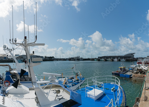 offshore fishing boats in the commercial harbor and port of Granville on the Normandy coast photo