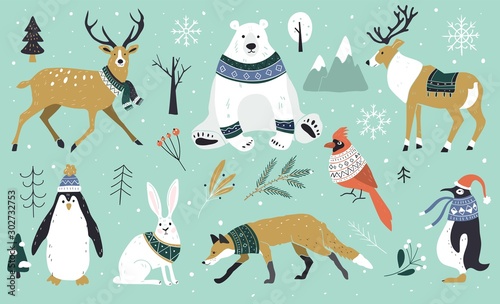 Set of Christmas animals in the forest, bear, fox, hare, reindeer, penguin. Scandinavian style.Winter animals in a sweater and scarfs. Hand drawn characters cartoon flat design.