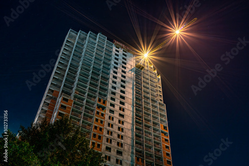 Tower crane at a construction site at night.