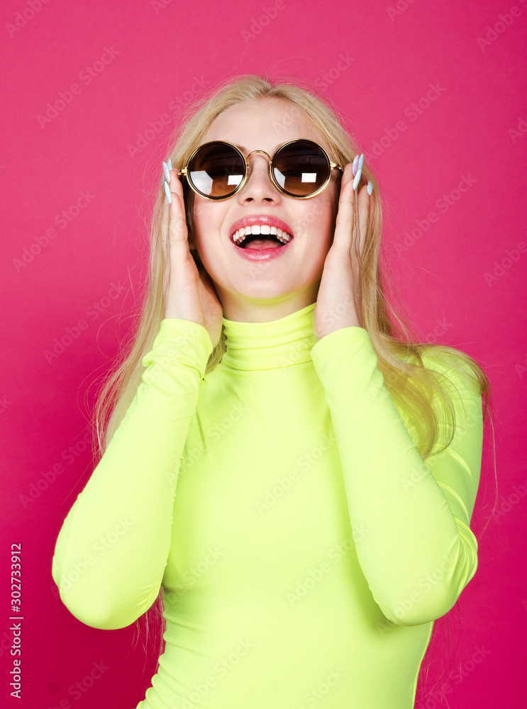 Portrait of fashion blonde laughing smiling model girl young woman wearing stylish with sunglasse isolated on a pink Portrait of fashion blonde laughing smiling model girl young woman wearing stylish with sunglasse isolated on a pink