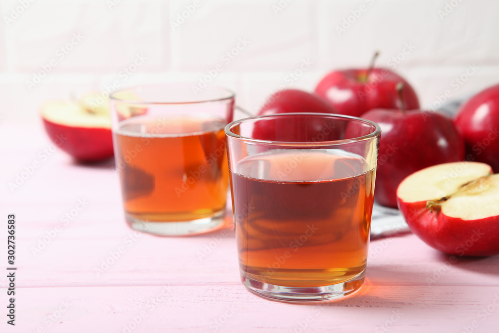 apple juice from red apples on the table. apple juice from red apples on the table.