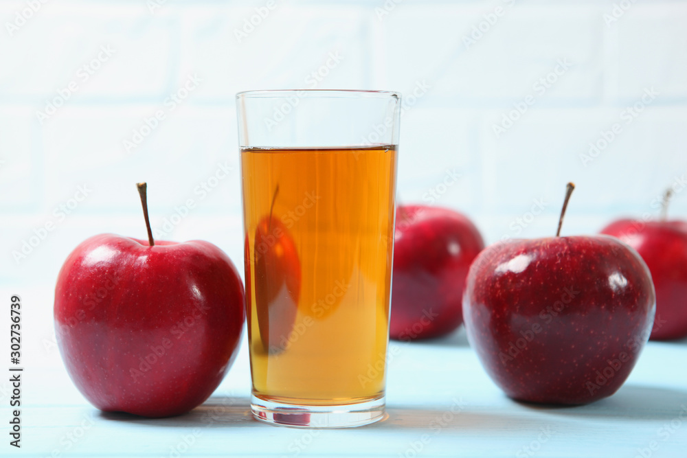 apple juice from red apples on the table. apple juice from red apples on the table.