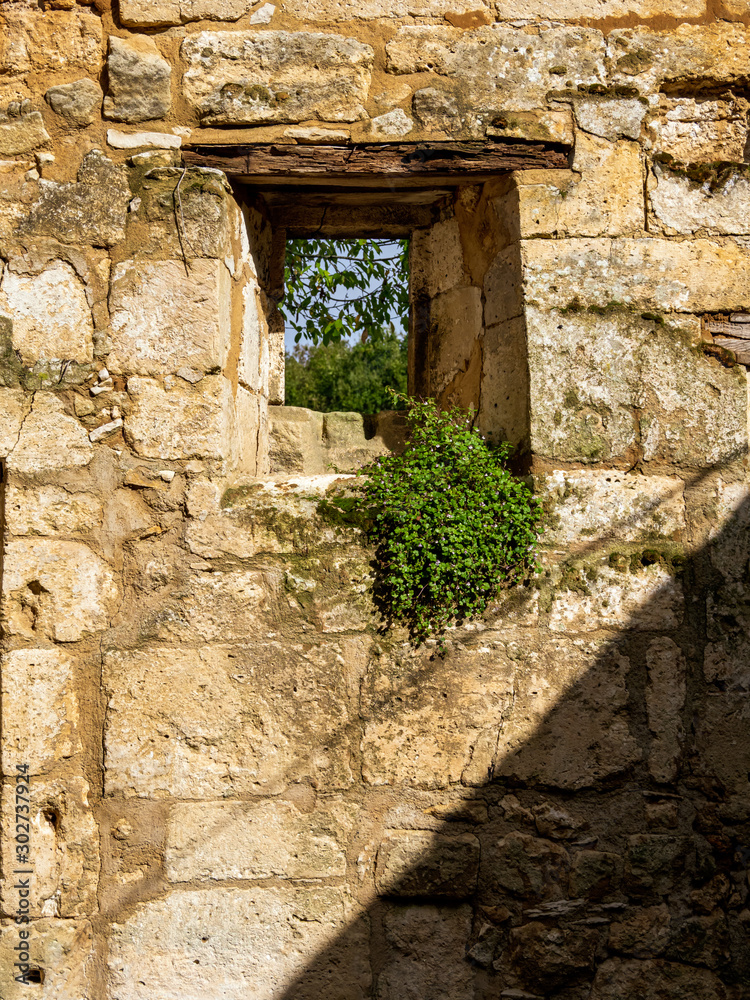 Window in medieval castle ruins with sun shining through, feelings of hope and positive