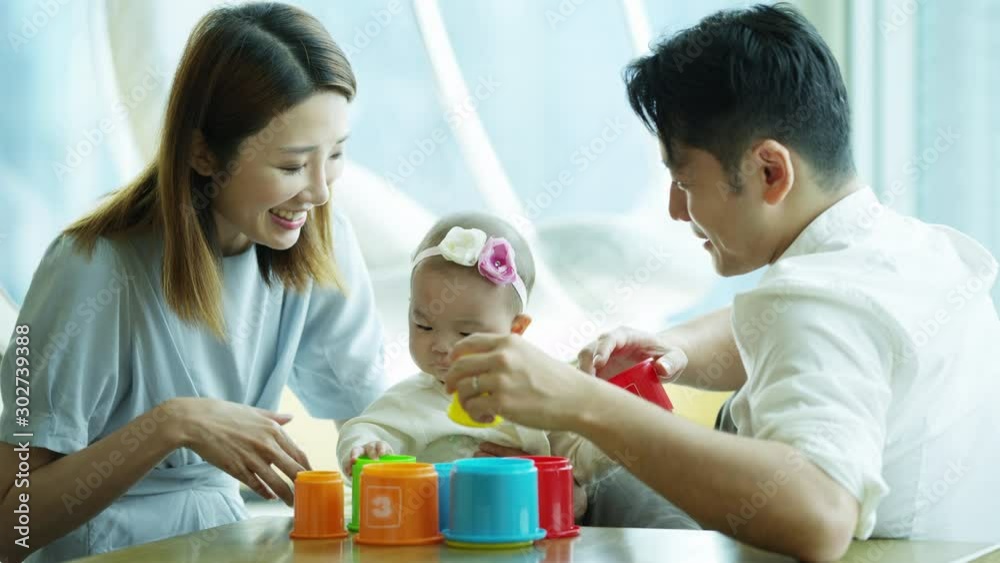 Chinese mum dad baby playing educational toy cups Chinese mum dad baby playing educational toy cups