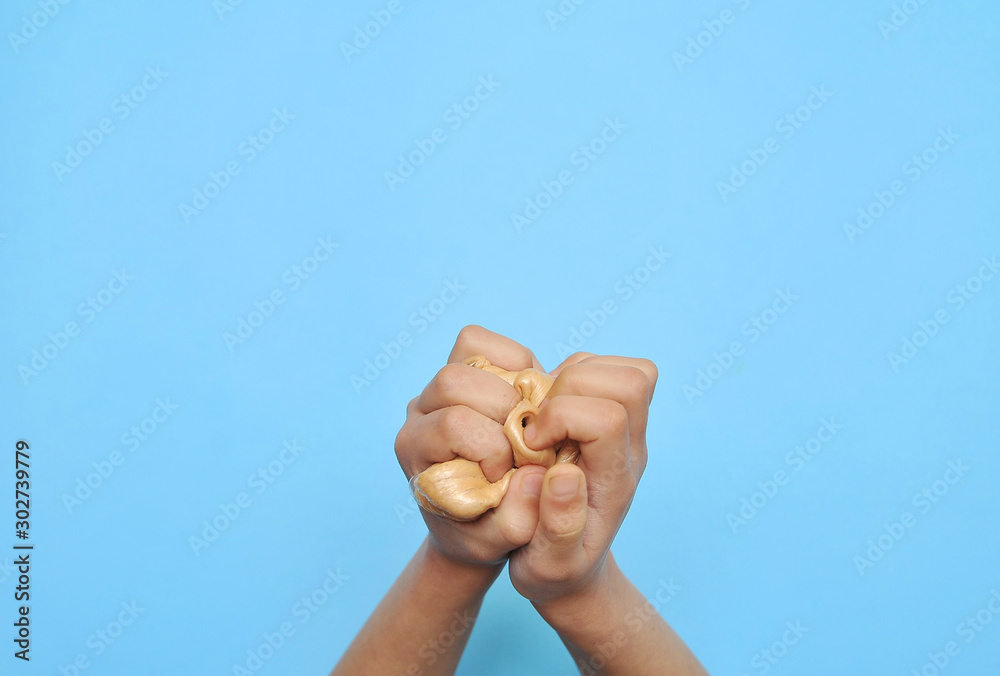 Child hands with slime on blue background. Child hands with slime on blue background.