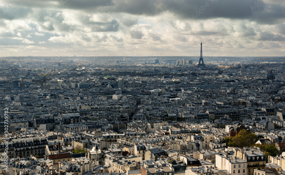 Cityscape of Paris on cloudy day. Visible Eiffel Tower