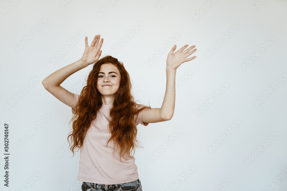 girl with a sly grimass dances raising her hands up in teenage clothes girl with a sly grimass dances raising her hands up in teenage clothes