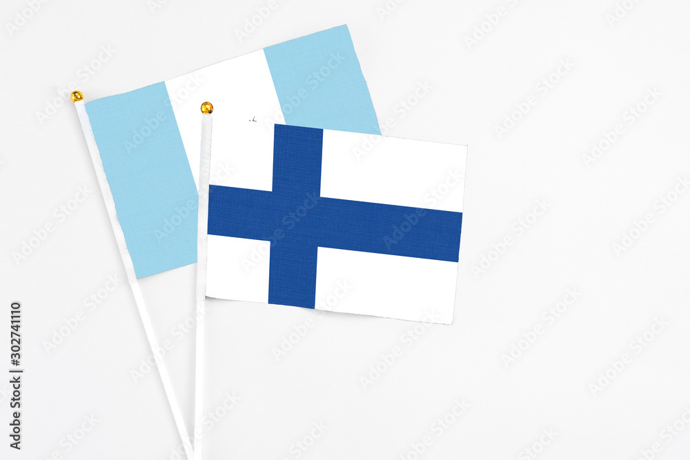 Finland and Guatemala stick flags on white background. High quality fabric, miniature national flag. Peaceful global concept.White floor for copy space.