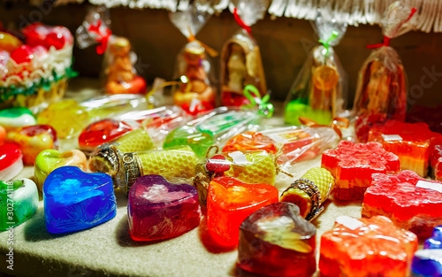 Handmade soaps for sale at stall of Christmas market in Riga, Latvia. Europe in winter. Street Xmas and holiday fair. Advent Decoration and Stalls with Crafts Items on Bazaar