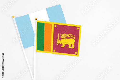 Sri Lanka and Guatemala stick flags on white background. High quality fabric, miniature national flag. Peaceful global concept.White floor for copy space.