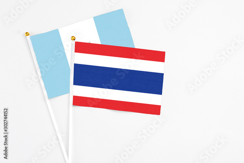 Free Download Thailand and Guatemala stick flags on white background. High quality fabric, miniature national flag. Peaceful global concept.White floor for copy space. - GFXLoad