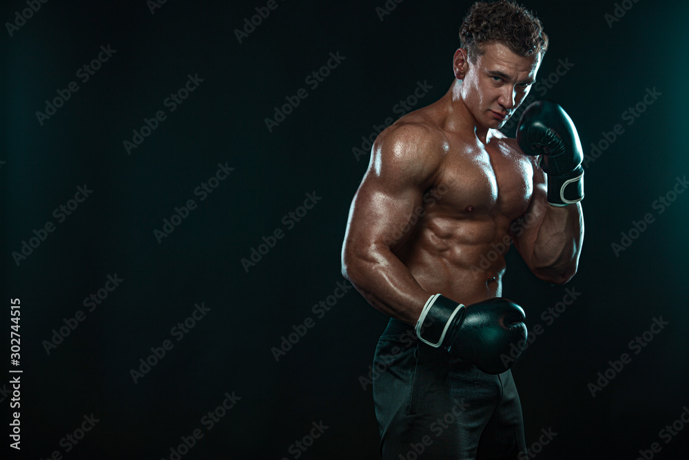 Boxer, man fighting or posing in gloves on black background. Fitness and boxing concept. Individual sports recreation.