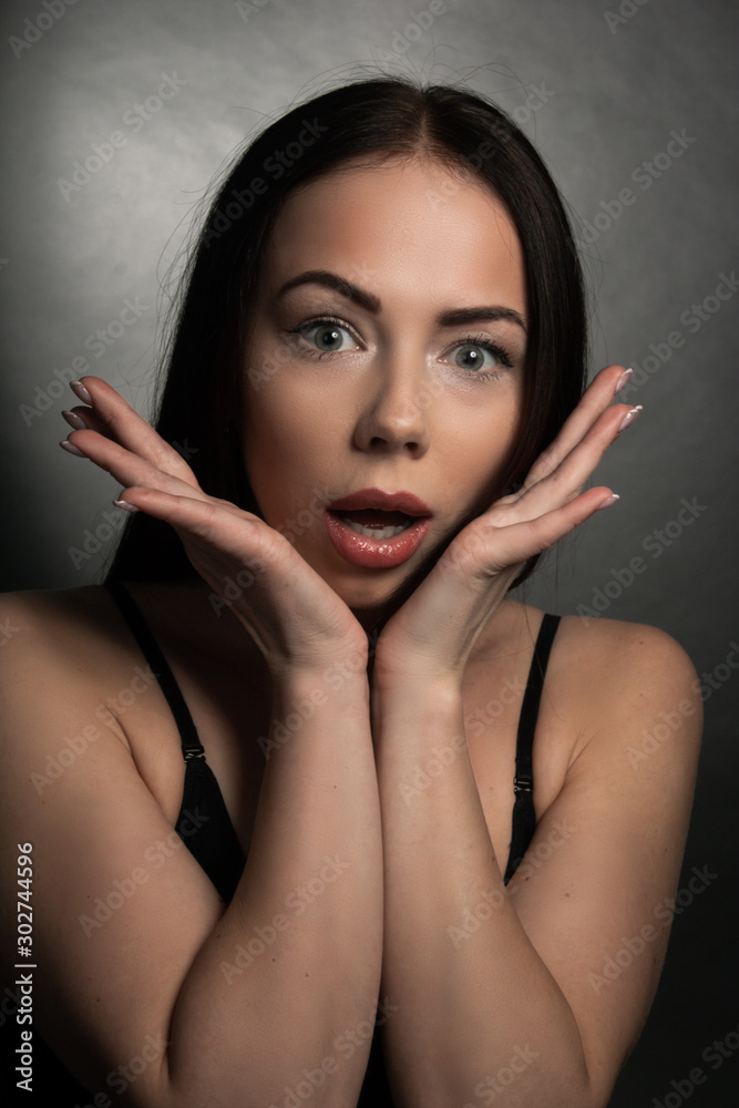 portrait of a young surprised girl propping her chin in her hands portrait of a young surprised girl propping her chin in her hands