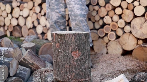 Lumberjack chopping firewood using axe, logs splitting. splitting wood and cutting firewood. slow motion