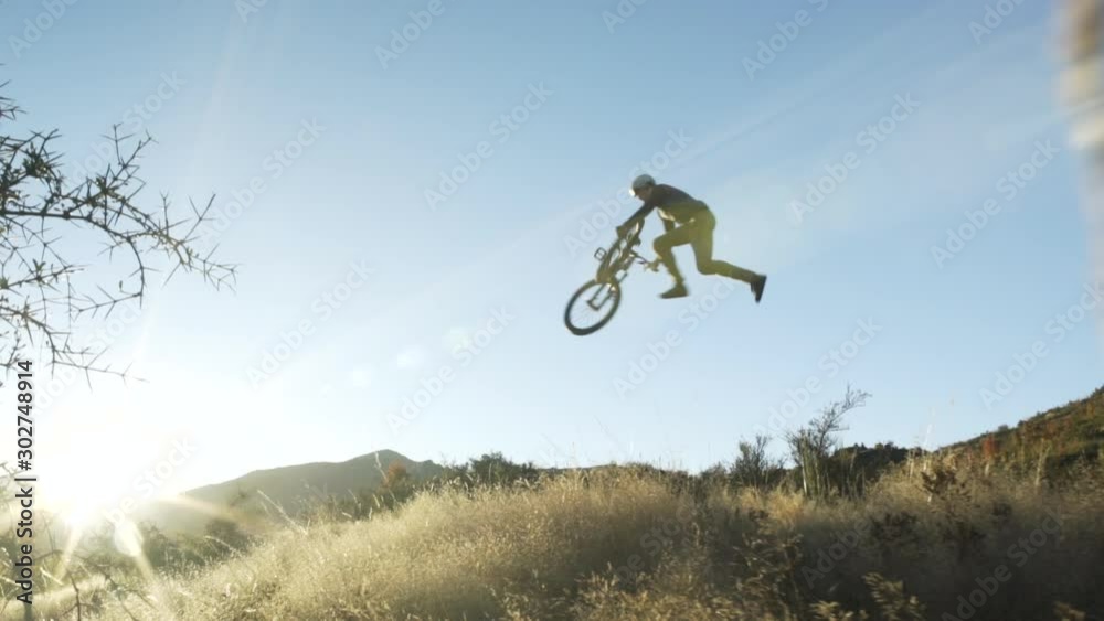 Bike rider practice tricks over ramp The Remarkables